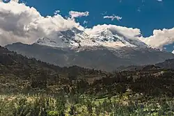 Snow-covered Mount Huascarán seen from a green valley