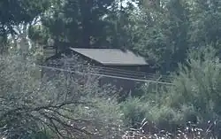 The Hunt Bass Hatchery Caretaker's House was built in 1936 and is located in the Phoenix Zoo grounds at 455 N. Galvin Parkway. Following the Great Depression, Governor Hunt (Arizona's first elected governor) commissioned a bass fish hatchery to be established in the Papago Park of Arizona during 1932. The property was listed in the National Register of Historic Places on January 23, 2003, reference: #02001723.