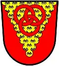 Mander (England): Gules, on a pile invected erminois three annulets interlaced two and one of the field.