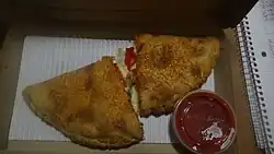 A P'Zone, cut in half, set inside a pizza hut box