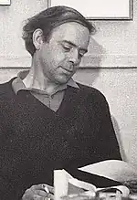 A 1972 photograph of Alan Plater, seated with paper in one hand and a cigarette in the other