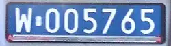 A dark blue plate reading W005765
