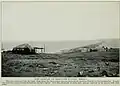 View of part of Port Dezhnev, 1913. The American-style cabins near the lagoon are probably a trading station.