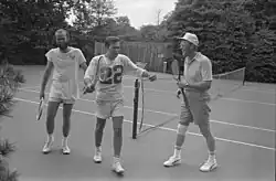 Gerald Ford, Donald Rumsfeld, and David Kennerly following a tennis match on the court in 1976