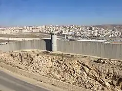 Israeli watchtowers and wall at the checkpoint of the Palestinian refugee camp of Qalandia, 2014.