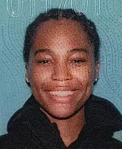 Headshot of Quenlin Blackwell on a blue background