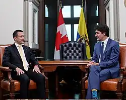 Noboa and Justin Trudeau are sitting together in a negociation table.
