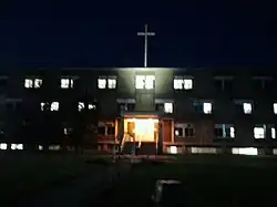 RMC at night, with new cross replacing bell tower.
