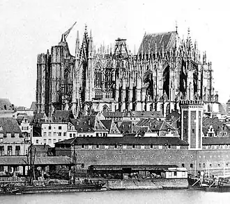 The unfinished cathedral in 1856. The east end had been finished and roofed, while other parts of the building are in various stages of construction.
