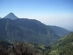 Looking from the ridgeline down into the old volcanic edifice, with the peak of Volcan Santa Maria in the background.