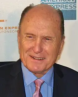Headshot of Robert Duvall smiling and looking to the bottom left of the camera, in 2007