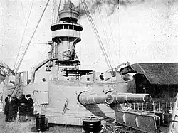 A large, round turret with two guns on a warship