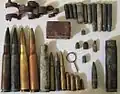 Artifacts found at the former Sahuarita Air Force Range, including a 20&nbsp;mm anti-aircraft gun casing and belt link, M2 bullets and casings, M1919 bullets, casings, and a machine gun belt link, M1 Garand bullets, casings, and a stripper clip, M1 Carbine bullets and casings, M1911 bullets and casings, a .22 bullet and casing, some unidentified casings, and an Mk 2 grenade pin.
