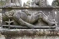 As the resurrected Jesus emerges from the tomb a soldier lies on the ground deep in sleep. Jesus' feet can be seen at the top of the photograph.