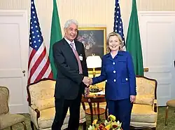 Secretary Clinton shakes hands with Libyan Foreign Minister Kousa