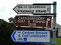 Three bilingual Irish-English directional fingerposts