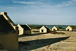 Image 21The forced African migrants brought to the Caribbean lived in inhumane conditions. Above are examples of slave huts in Dutch Bonaire. About 5 feet tall and 6 feet wide, between 2 and 3 slaves slept in these after working in nearby salt mines. (from History of the Caribbean)