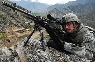 A U.S. soldier scans for activity during a combat patrol in Afghanistan, 2009.