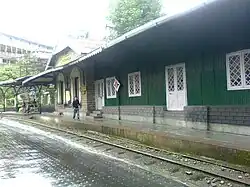Station platform with a green building