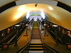 Escalators with bronze uplighters at Southgate Station