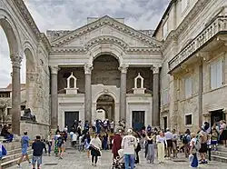 Tourists visiting the remains of a Roman palace.