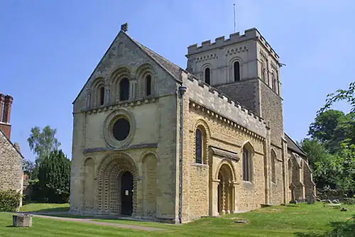 St Mary the Virgin, Iffley, 12th century, shows the detailed carving, particularly chevrons, and the side portal typical of Britain.