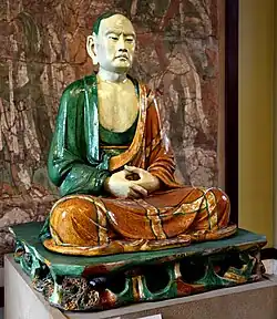 Stoneware figure of a luohan, from Yixian, China, Liao dynasty, 907–1125 CE. British Museum