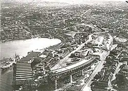 Aerial view of Milsons Point during construction of the Sydney Harbour Bridge