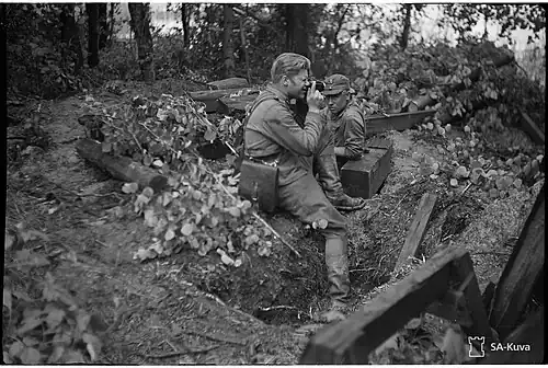 A TK man photographing at the frontline.
