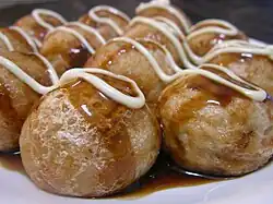 Takoyaki served with Japanese Worcester sauce and mayonnaise