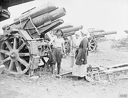 Two nurses checking a 21 cm Mörser 16 heavy howitzer at a dump of German artillery captured by the British Fourth Army.