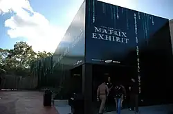 A futuristic, monolith-style black building that houses the Official Matrix Exhibit.