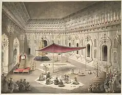 Funeral of Asaf-ud-Daulah in the year 1797 under a canopy inside the Bara Imambara; (note:Flag (green) of the Mughal Empire raised higher than the Awadh flag)