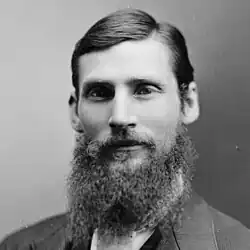 Black and white portrait photograph of male with beard