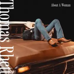 The cover features Thomas Rhett lying down on the front top of a brown vehicle, wearing a green jacket, blue jeans, brown cowboy boots and a white cowboy hat on top of his face. The artist's name appears sideways on the left and the album title is on the top-right corner, both colored in white.