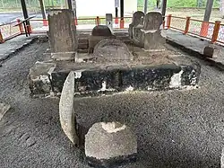 A rectangular stone tomb where the stones are held in place with cement