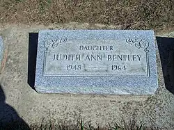 A color photograph of the headstone of Judith Ann Bentley, who died in 1964. She was born in 1948. The headstone identifies her as a daughter.