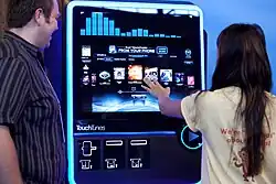 A large touchscreen is interacted with at a product demonstration