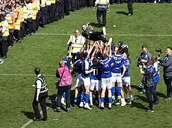Ipswich Town manager Kieran McKenna is thrown into the air by his players on the pitch at Portman Road after Town sealed back-to-back promotions and a first return to the Premier League in 22 years.