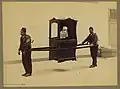 Client inside a sedan chair carried by two bearers