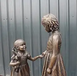 Life size, bronze, of two sisters holding hands