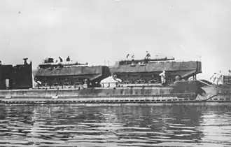 Two Type 4 Ka-Tsu with torpedoes on the deck of a IJN submarine