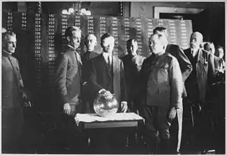 Important looking man drawing a capsule from a bowl
