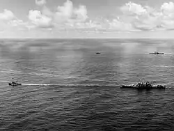 USS&nbsp;Canberra (foreground) and Houston (background) under tow on 18 October