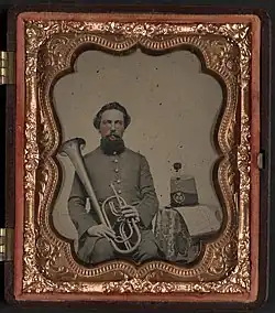 Unidentified soldier of Co. H, 13th Virginia Infantry Regiment in uniform with over the shoulder saxhorn
