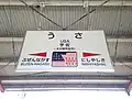 The station name board makes a visual pun about the station name and the United States. There is also a graphic of the Usa shrine.