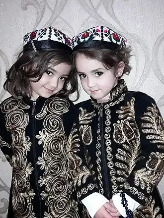 Uzbek children wearing an embroidered chopon known as a zarchopon