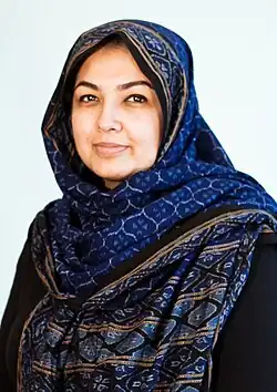 A portrait of Uzma Z. Rizvi wearing a blue dupattā.