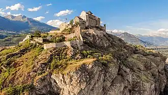 Valère Basilica hill in Sion. Note the prevalence of steppic vegetation in the foreground and vineyards in the background.