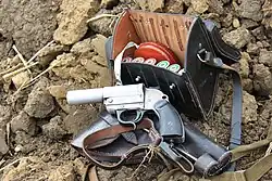 Flare gun with holster and cartridges in leather case displayed at a World War II reenactment event in 2011